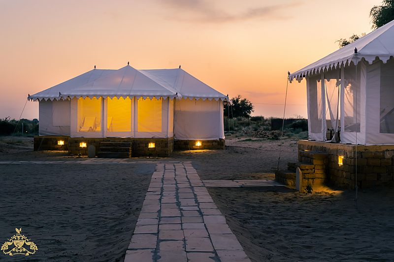 Desert camp in Jaisalmer - Jadam Resort tents glowing at evening