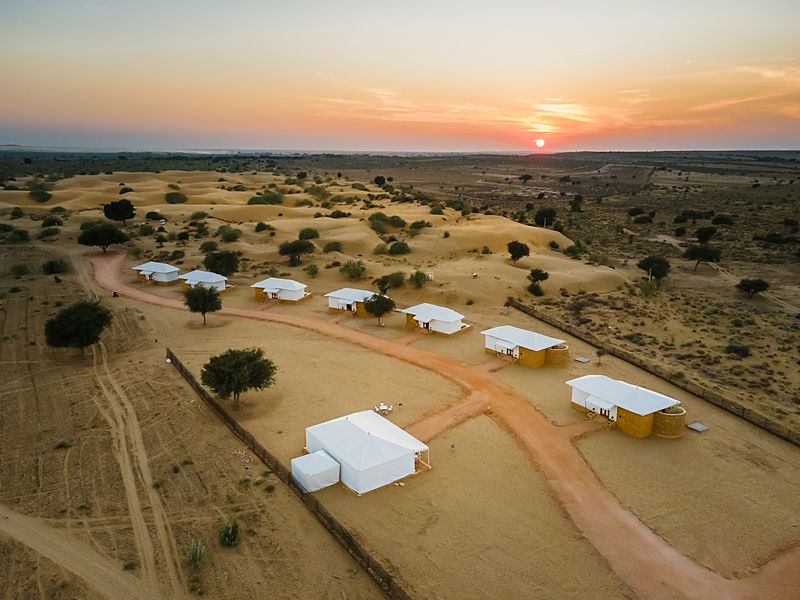 Aerial view of luxury desert camp in Jaisalmer on golden dunes