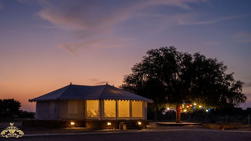 Tents with warm lights at dusk - Jadam Resort Jaisalmer