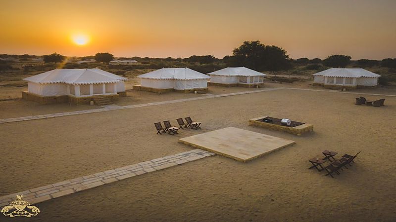 Resort tents against Jaisalmer sunset sky
