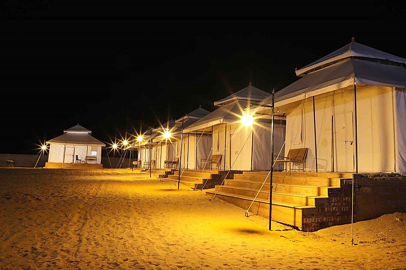 Lantern lit royal tents at night Jaisalmer desert camp